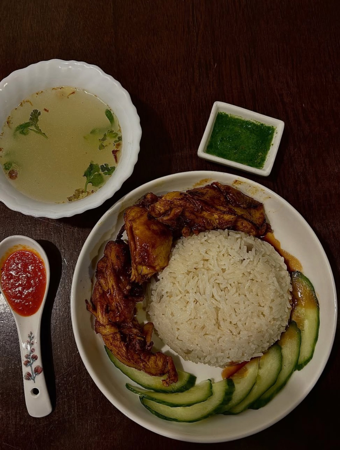 Hainanese chicken rice with broth, chilli and ginger sauces
