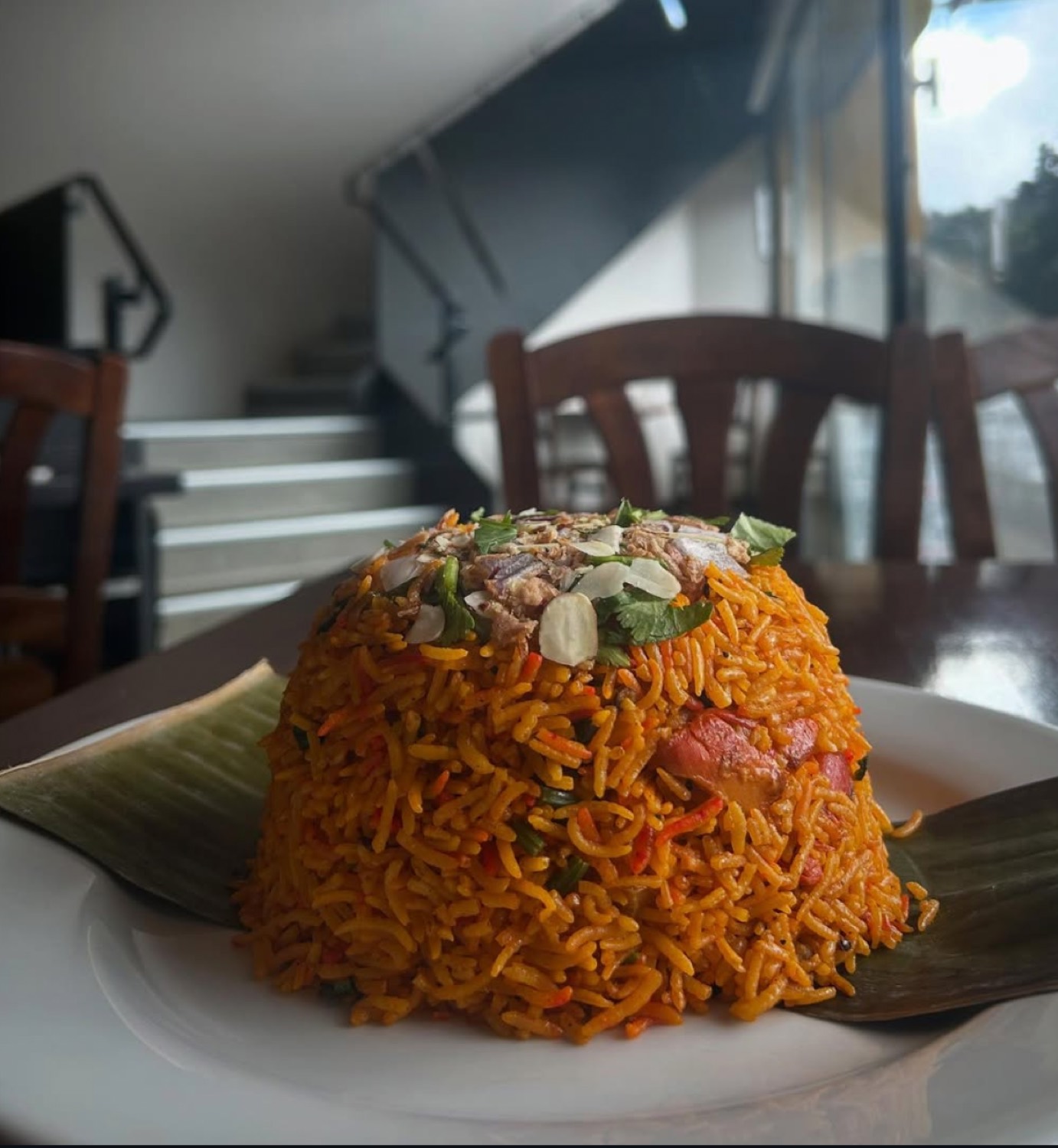 Nasi goreng moulded on a plate with a banana leaf